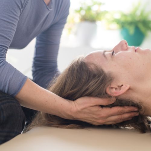 A therapist practices NeuroAffective Touch with her client.